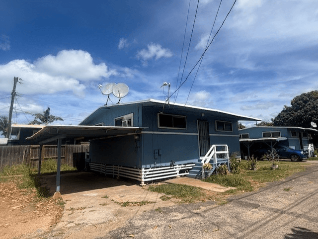 A blue house with a satellite dish on the roof.